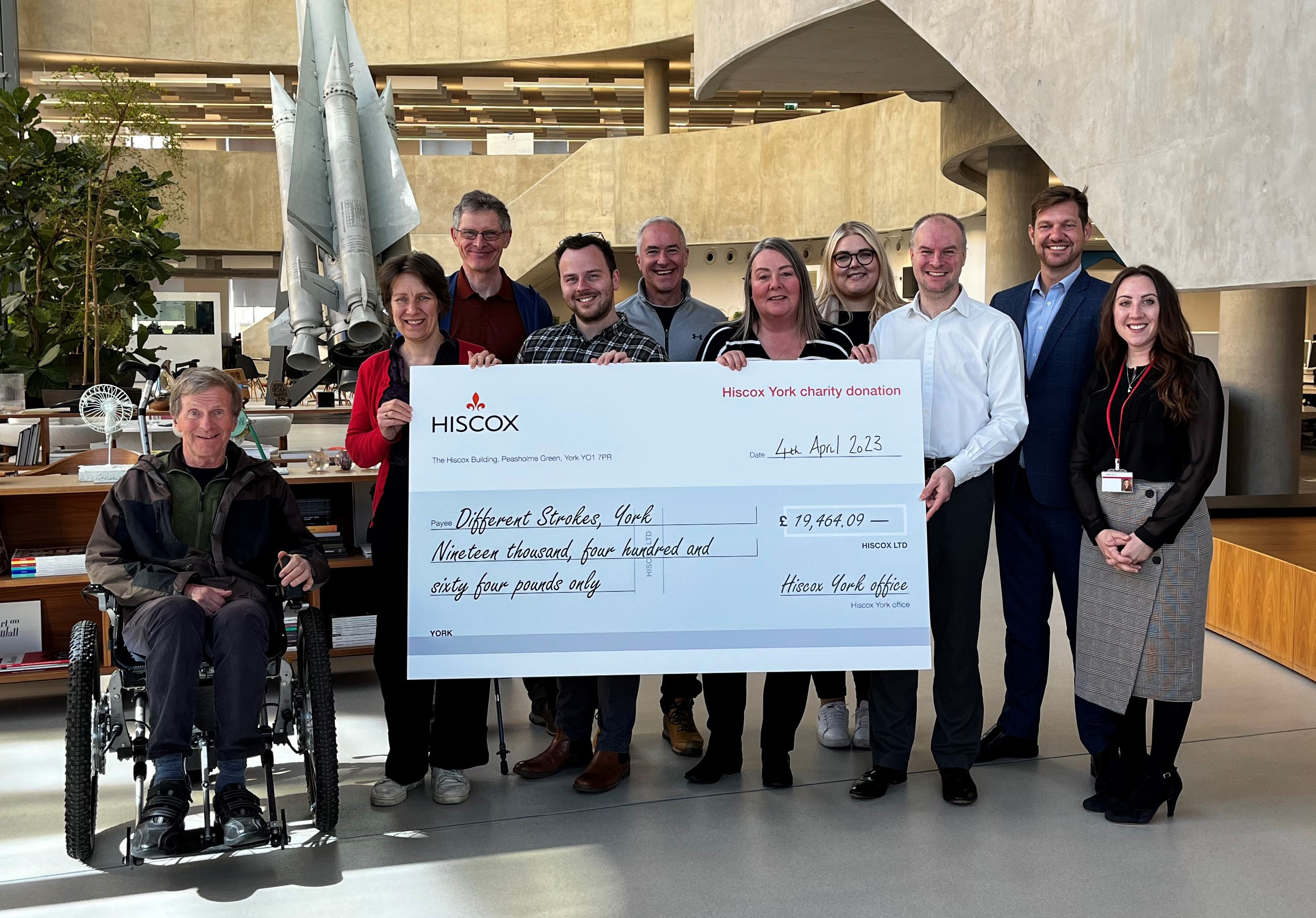 Hiscox York employees present a cheque for almost £20,000 to Different Strokes