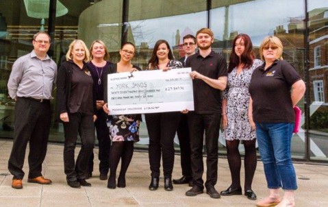 Hiscox staff in york handover cheque to York Sands