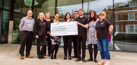 Hiscox staff in york handover cheque to York Sands